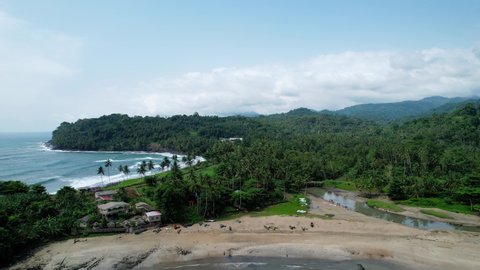 Aerial view overlooking the a Baia da Praia do Rei agua Ize beach in Sao Tome - rising, drone shot