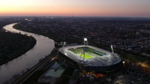 Bremen, Germany - March 2022: Aerial night view over illuminated Weserstadion, home stadium of 2. Bundesliga football club SV Werder Bremen.