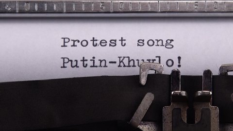 Kyiv, UKRAINE - APRIL 02, 2022: Typing phrase "Protest song Putin-Khuylo!" on retro typewriter.