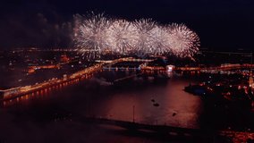 The aerial video the huge and beautiful show fireworks over the Neva River water area on annual celebration of a student's holiday Scarlet Sails at night in Russia, St.Petersburg, landmarks of city