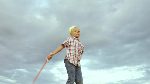 little child kid superhero waves sword against sky. boy son plays crown his head king. outdoor activity child. boy playing game with sword. children dream holiday mood. happy family. help protector