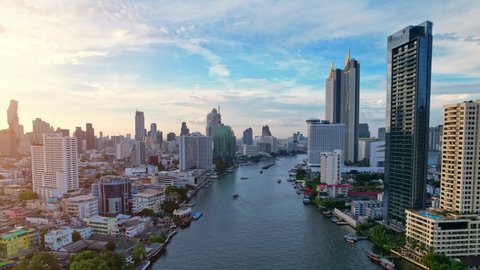 BANGKOK THAILAND - 2022 March 28, 4K UHD : Bangkok thailand aerial city view drone footage over the city. skyscraper and high rise buildings at sunset. 4k aerial city
