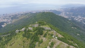 Inscription on video. Genoa, Italy. Forte Sperone is a key point of the 19th-century Genoese fortifications and is located on top of the Mura Nuove. View of Genoa. Text from small balls, Aerial View,
