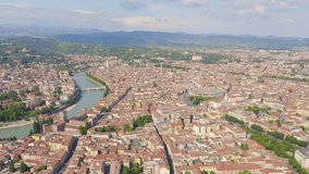 Inscription on video. Verona, Italy. Flying over the historic city center. Arena di Verona, summer. Different colors letters appears behind small squares, Aerial View, Departure of the camera