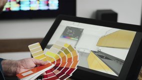 A professional graphic designer selects the color for the interior. A man works with modern equipment for designers and architects. - Powered by Shutterstock - Get 15% off with code: PIKWIZARD15