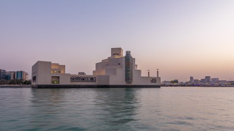 Doha skyline with Museum in Doha day to night transition timelapse, Qatar, view with buildings and boats behind it