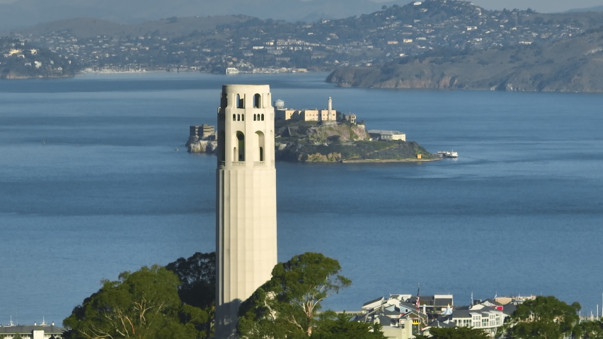Aerial view of Alcatraz Island with lighthouse on a clear morning. Alcatraz Island with fortified buildings and old lighthouse with San Francisco Bay behind.High quality 4k footage