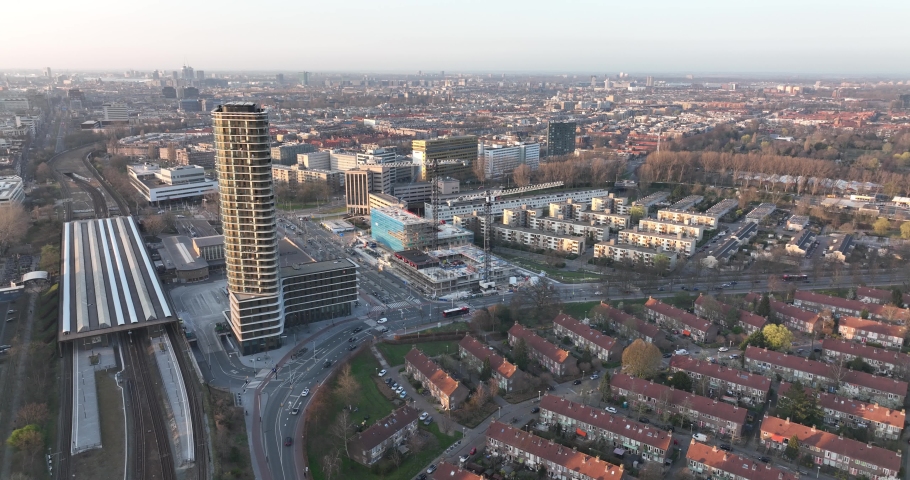 Amsterdamn Amstel urban city aerial drone view transportation and urban residential construction towers. Infrastructure train station business buildings and skyline. Water canal.