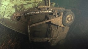 Scuba divers swims on the Shipwreck Swedish ferry MS Zenobia. Wreck diving. Mediterranean sea, Cyprus. Maritime disasters. Underwater 4K video filming Shot Of Sunken Ship. World tragedies under water