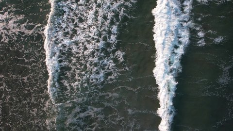 Top down view of many stormy waves creating textured wave foam. Black sea waters forming waves. 4K Drone Video