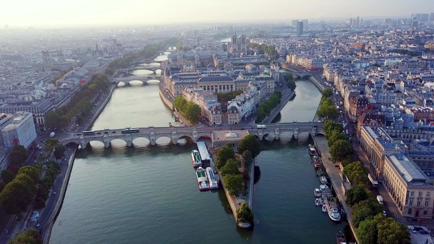 Morning aerial panoramic view on western tip of Ile de la Cite island with traffic on Pont Neuf, Paris, France.