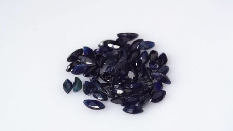 natural dark blue sapphire marquise cut gemstone on turning table