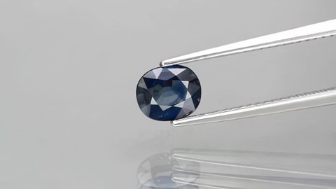 natural dark blue oval sapphire gemstone on the turning table
