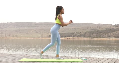Fitness black woman doing lunges exercises for leg and buttocks muscle workout training, outdoors.