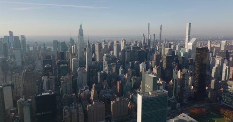 Slide and pan footage of skyscrapers in midtown. Aerial view of iconic One Vanderbilt, Chrysler and Empire State Building. Manhattan, New York City, USA in 2021