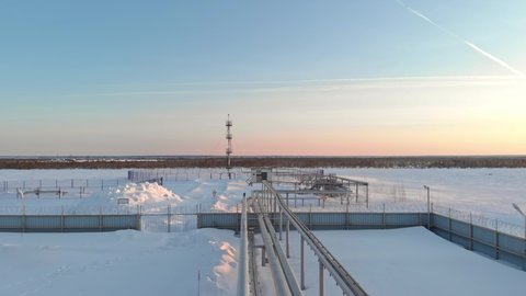 A drone flies over a pipeline, a gas pipeline at an oil and gas field in Siberia. Natural gas reserves in Russia or Canada. Rising gas prices in the world. Flight over the pipeline in winter.