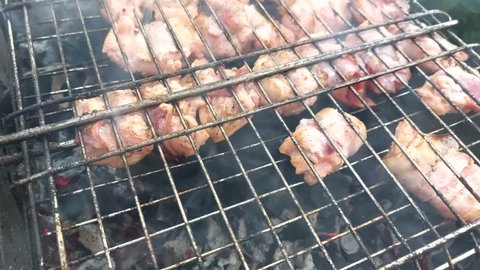 Fresh salmon fish and bacon meat on on barbecue grill grate. Barbecue cooking on fried smoked grill. Healthy lunch roast bbq on countryside campfire. Camping food, picnic, weekend resting concept