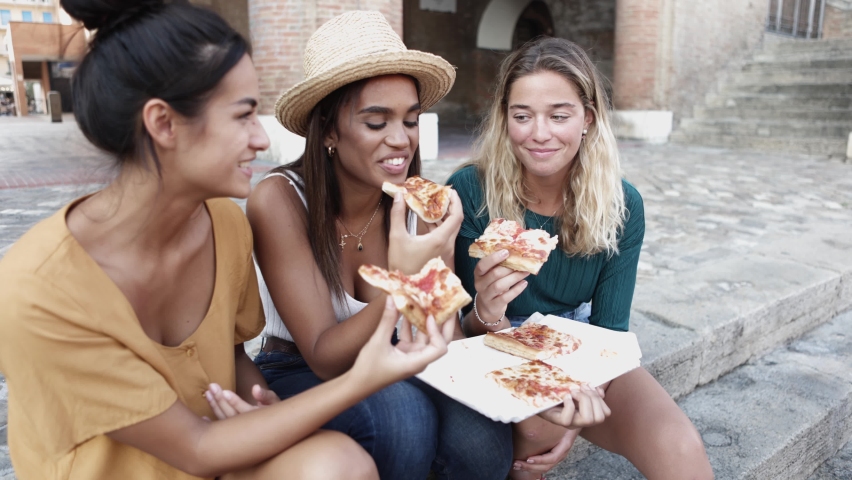 Happy millennial friends enjoying the weekend together while eating pizza in an italian city - Young people lifestyle concept.  Royalty-Free Stock Footage #1089101003