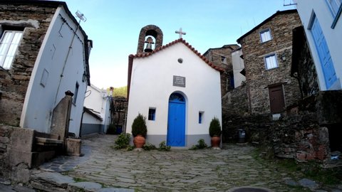 SLOW MOTION SHOT The picturesque little schist village of Piodão clings to a steeply terraced mountainside deep within the foothills of the Serra de Açor range in central Portugal. Saint Peter Chapel.