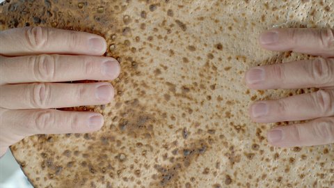 Super slow-motion of Pesach Matzah breaking. This unleavened bread is symbolic of the Jewish festival of Passover and the Jews exodus from Egypt.