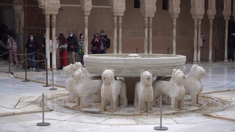 Granada, Spain- February 2022: Visitors in the Court of the Lions, 14th century, Alhambra, Granada, Spain. Travel and landmarks. 