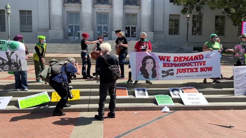 Berkeley, CA - April 9, 2022: 4K HD video panning around unidentified participants at Abortion Rights Rally with counter protestors stand on the other side of Sproul Plaza