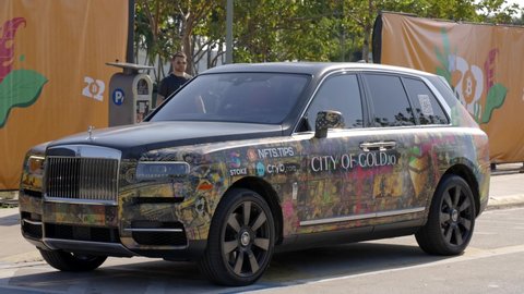 Miami Beach, FL, USA - April 6, 2022: Rolls Royce luxury car wrapped with bitcoin and nft graphics