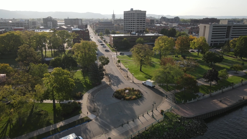Panorama over round about in Riverside Park, La Crosse, Wisconsin. Bluffs, downtown area, South Park area, levy, Mississippi River, bridges, and beach area seen. Sun casting shadows. 