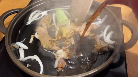 Chef Pouring Sukiyaki Soup into Pot to Make Hotpot