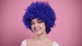 Close-up Portrait of Young Smiling Woman In blue Wig. Millennial woman blows kiss.