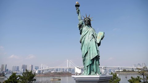 Odaiba Statue of Liberty and Tokyo skyscrapers with Rainbow bridge in the background, Japan. High quality FullHD footage
