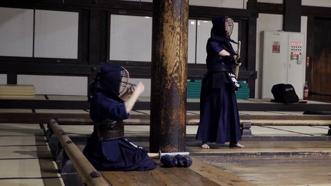 Tokyo, Japan - March 23, 22: Preparing for a Kendo practice in Dojo. Kendo warrior practicing martial art with the bamboo bokken. High quality 4k footage