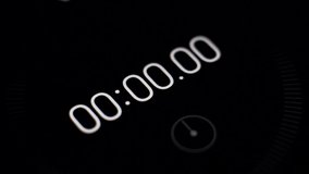 Close-up of the black screen of digital stopwatch with white running numbers. Time lapse 1 minute - Powered by Shutterstock - Get 15% off with code: PIKWIZARD15