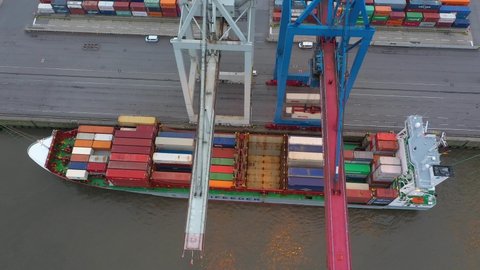 Drone shot of modern industrial port of Hamburg with containers from top view or aerial view. It is an import and export cargo port where is a part of shipping dock with ship
