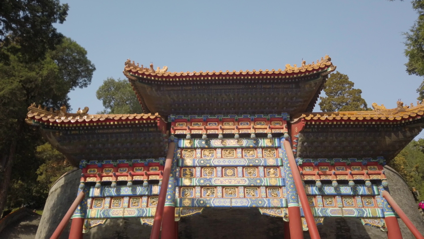 Walking towards Chinese ancient archway in tourism spot Beihai Park, Beijing.