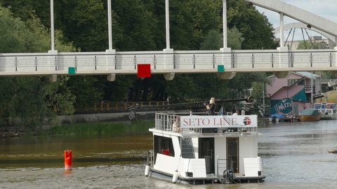 Tallinn Estonia 2021 August 12: The Seto Line boat on the river in Tallinn Estonia moving across the under the bridge