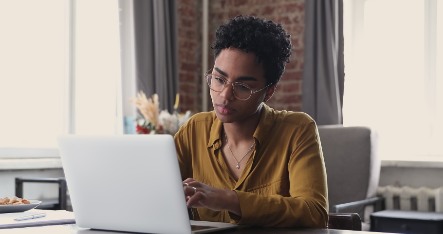 Tired young Black woman worker student take short pause in online work remove glasses massage nose bridge relax with closed eyes. Female employee overworked by pc feel fatigue suffer from eye strain Royalty-Free Stock Footage #1089117275