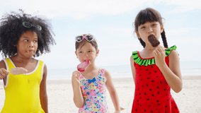Group of Diversity little African and Asian girl eating ice cream together while playing on tropical beach in sunny day. Happy children family enjoy and fun outdoor activity on summer holiday vacation - Powered by Shutterstock - Get 15% off with code: PIKWIZARD15