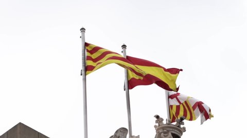 Barcelona, Spain – November 10, 2021:Awesome view of the Estelada the flag of Spain and the flag of Barcelona over the City Council of Barcelona