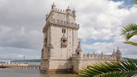 Revealing shot of the Belem Tower at the bank of Tagus River in Lisbon, Portugal. Torre de Belem tower is a popular tourist destination in Lisboa city. 