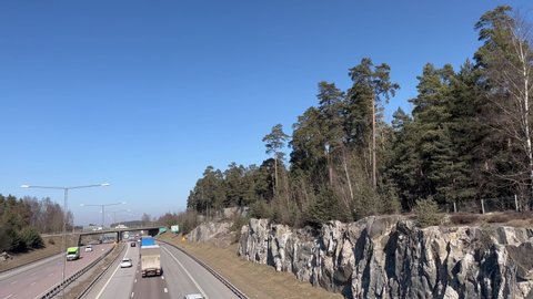 Stockholm, Sweden. 03-15-2022.  Swedish highway called E4. Blue sky and plenty of cars passing by.
