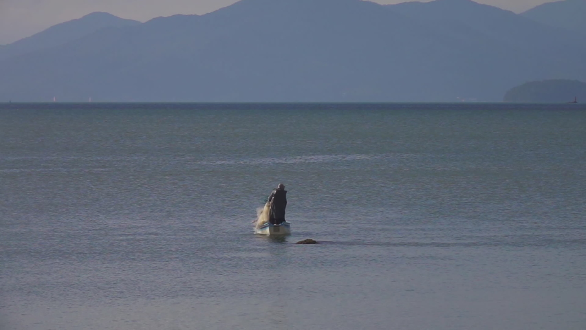 Fishermen Casting Fishing Net in Sea