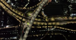 Aerial footage night view of modern city buildings with interchange overpass in shenzhen city,China