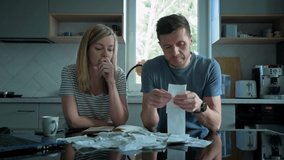 Man and woman checking payment bills in the kitchen at home. Planning family budget. Couple calculate bills and have stress - Powered by Shutterstock - Get 15% off with code: PIKWIZARD15