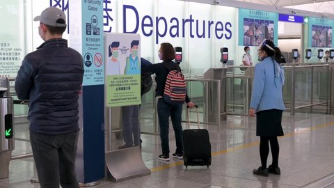 Hong Kong , Lantau Island , China - 02 20 2022: Passengers go through the security check at Chek Lap Kok International Airport departure hall in Hong Kong, China.