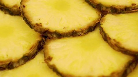 Juicy Pineapple Slices, Closeup. Isolated Background from Pineapple Slices, Tropical Fruits, Rotates. Healthy Vegan Food and Pineapple Diet.
