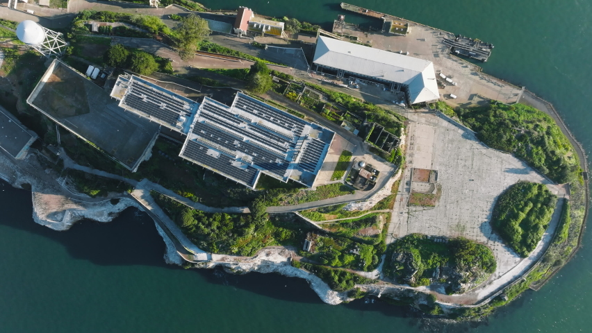 Aerial view of small island with military fortifications within the sea. Iconic landmark, surrounded with natural beauty of rocky landscape and the city in the background. High quality 4k footage