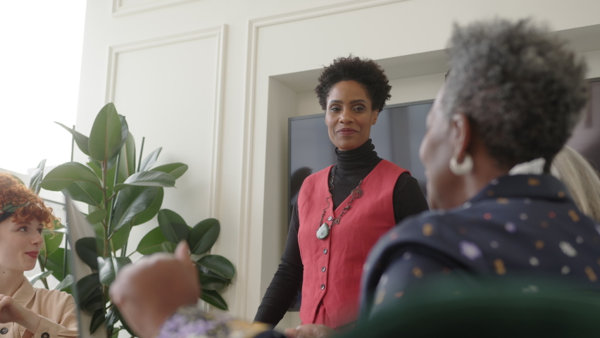 Slow motion of mature black woman talking in business meeting with multiethnic co workers | Shutterstock HD Video #1089144031