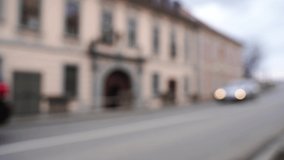 City blur background. Town outdoors interior. Modern road. Empty street. Business shop. Light bokeh view. Architecture backdrop. Moving car. 4K video with bicycle man