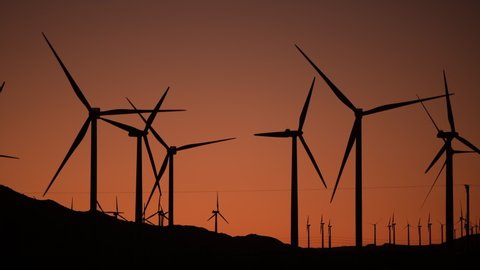 Wind Power Generation Using Wind Energy in Coachella Valley, California. Scenic Sunset. Green Power Industry Theme.